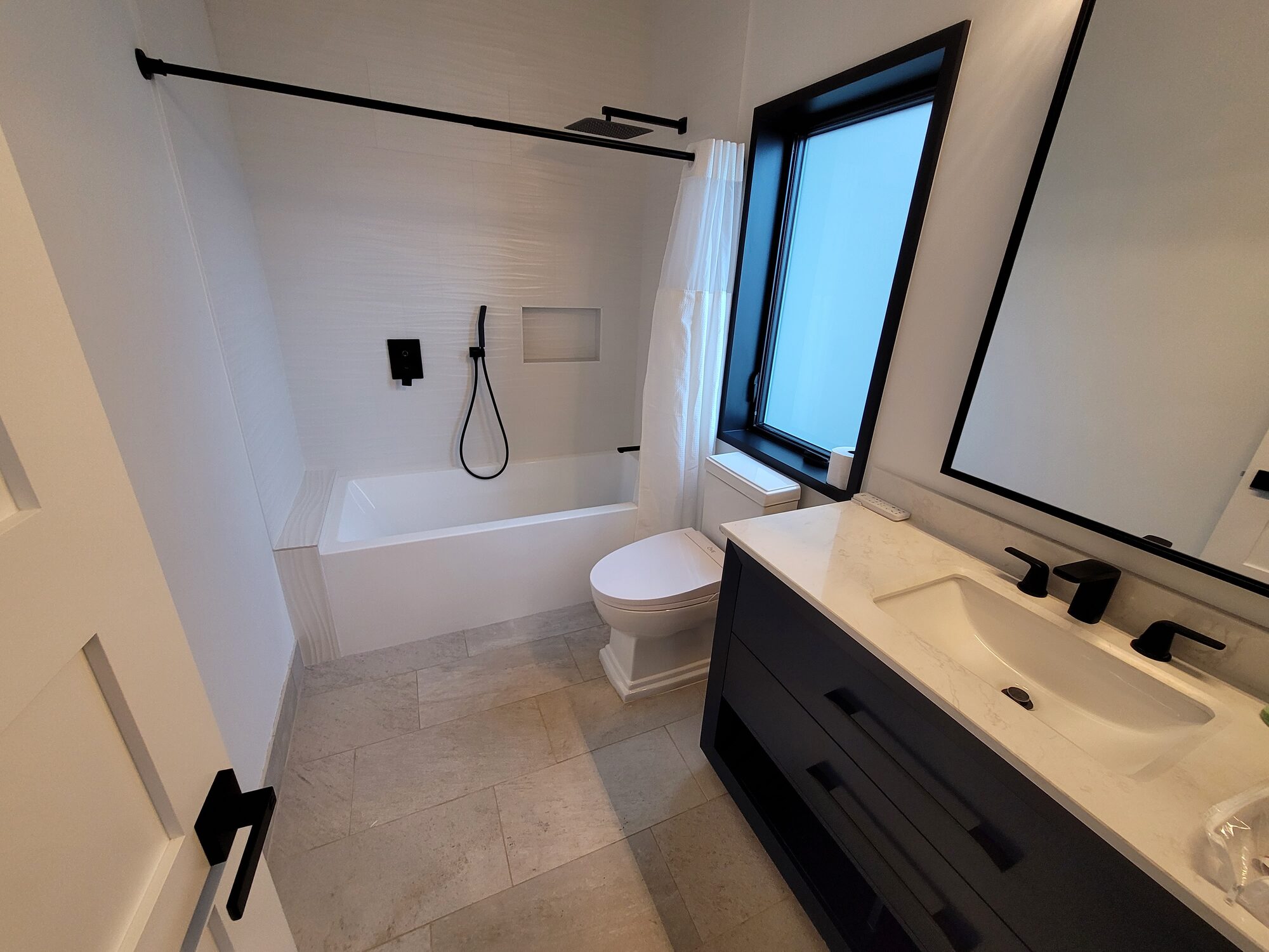 Bathroom with white tile shower