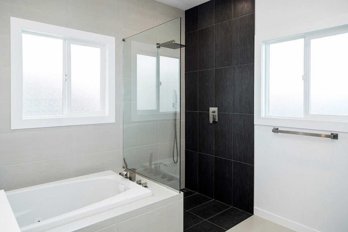 Bath with soaking tub and black-tile walk-in shower