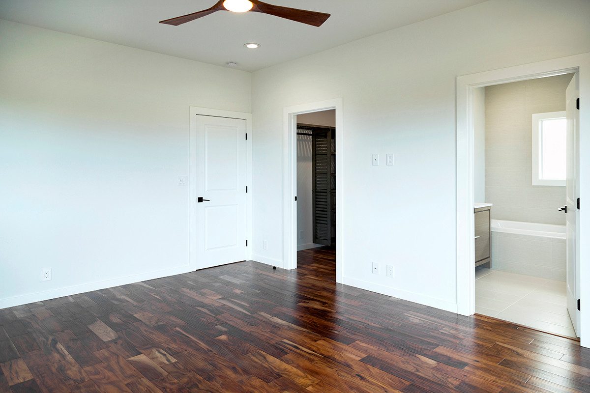 Bedroom with acacia floors and walk-in closet