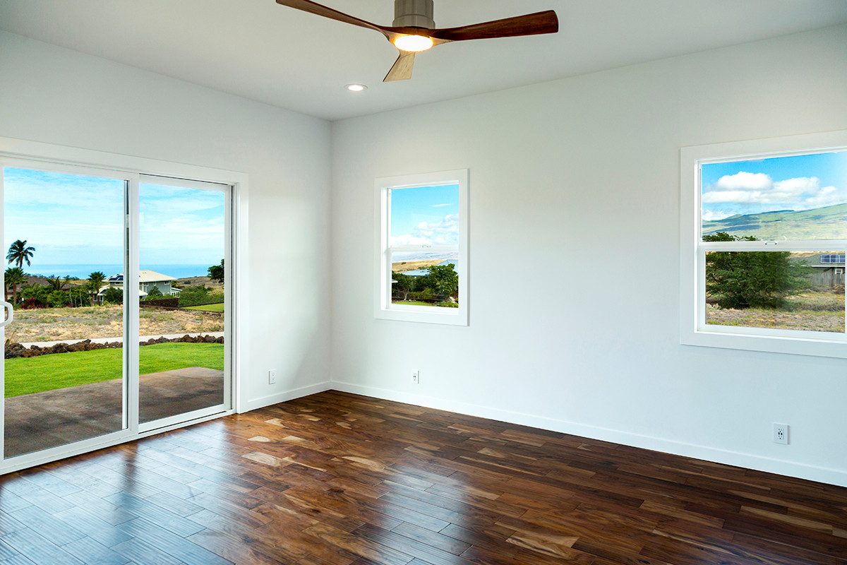 Bedroom with slider to the lawn and mountain view