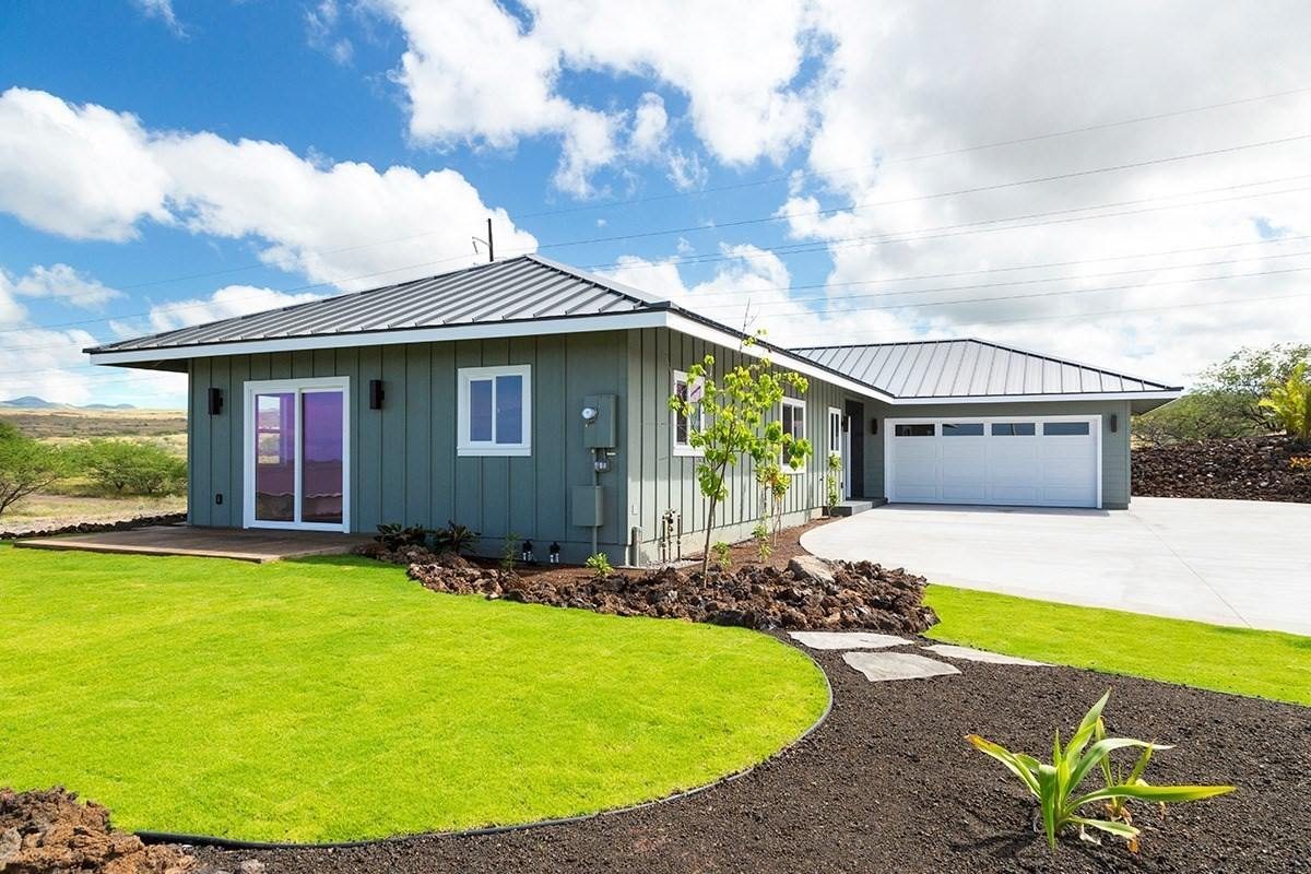 New home with standing-seam metal roof and fresh lawn, Waikoloa Village