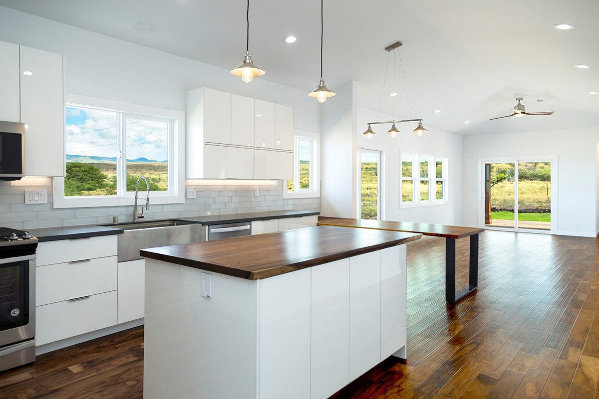Open kitchen with walnut island and acacia floors