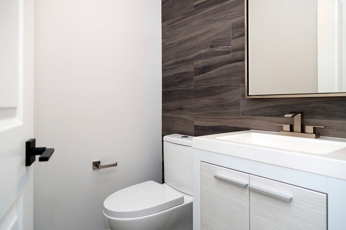 Powder room with wood-look tile accent wall